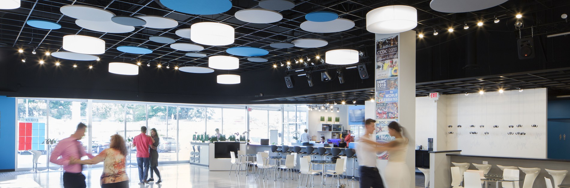 Dance studio with dancers and a seating area